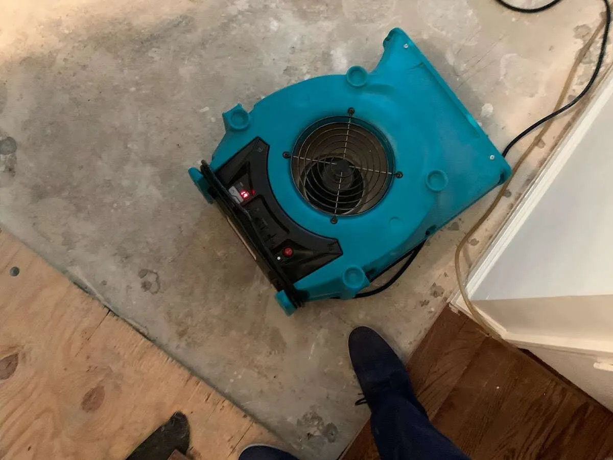Air mover drying subfloor during Leak Detection & Repair in Keystone